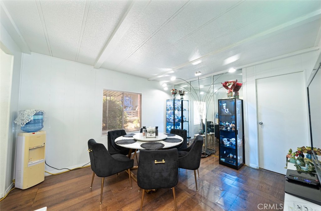 5700 Carbon Canyon Road, Unit 130 Brea, CA 92823 - Photo 7 of 17 a view of a dining room with furniture and wooden floor