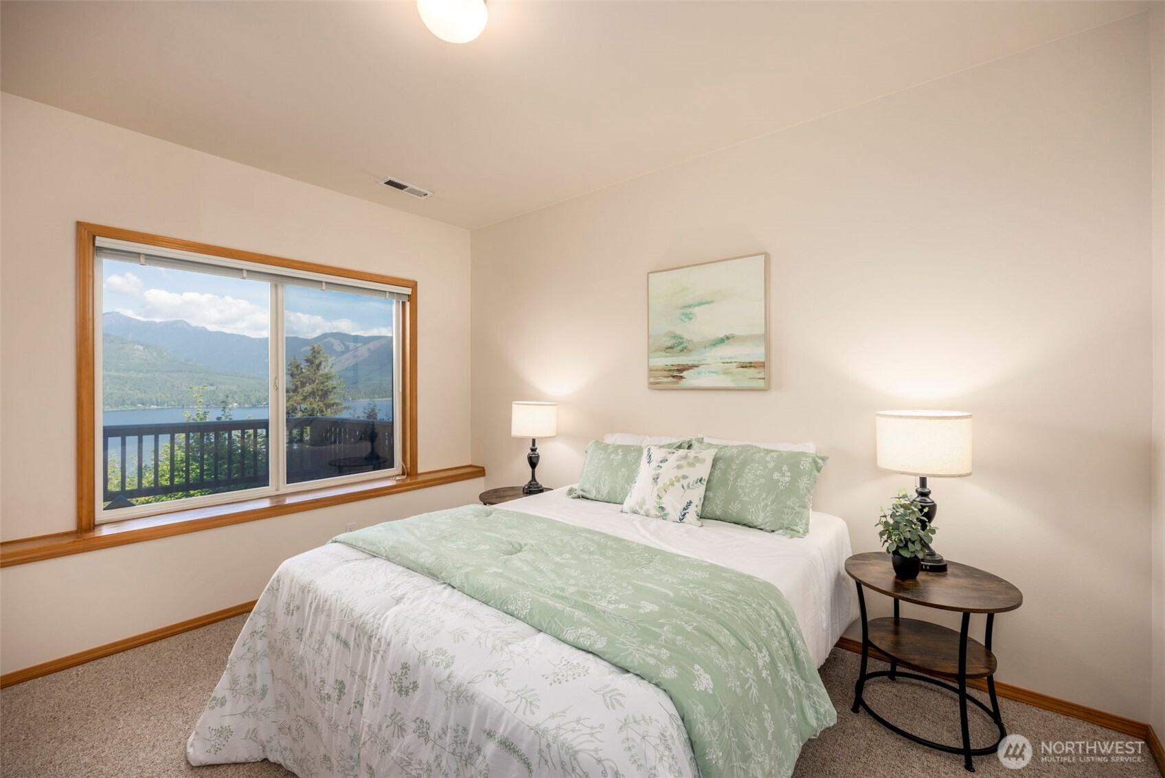 19736 Northwest Stavis Bay Road Seabeck, WA 98380 - Photo 30 of 39 a bedroom with a bed and a large window