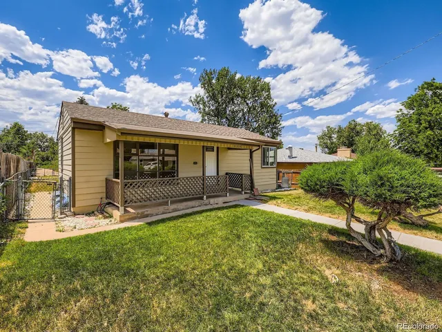 a view of a house with a yard and sitting area