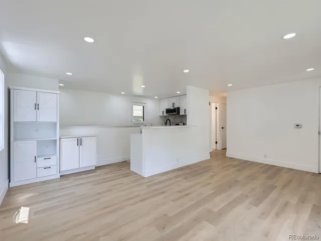 a view of kitchen with wooden cabinet