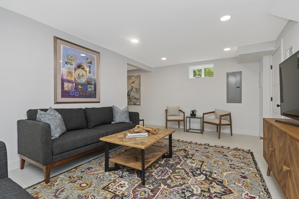 22 Stafford Road Newton, MA 02459 - Photo 18 of 28 a living room with furniture a rug and a flat screen tv