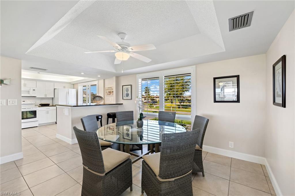 108 Penny Lane, Unit 4 Naples, FL 34112 - Photo 9 of 31 a view of a dining room with furniture