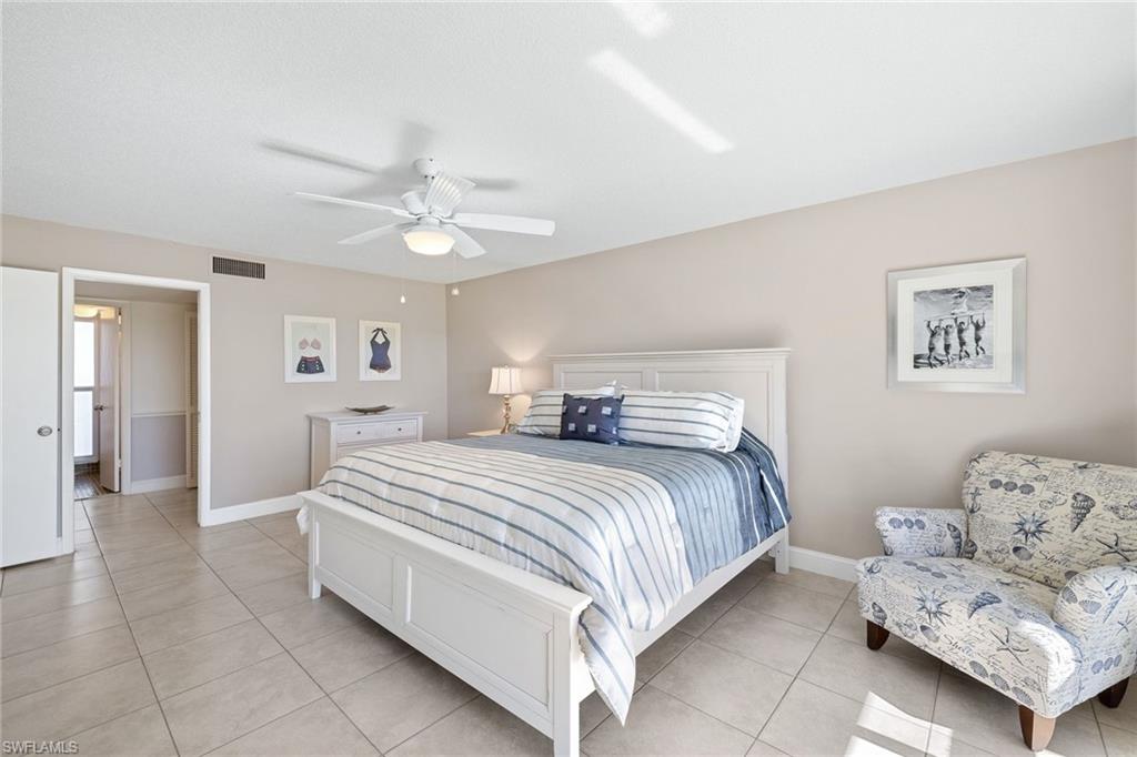 108 Penny Lane, Unit 4 Naples, FL 34112 - Photo 14 of 31 a spacious bedroom with a bed and a couch