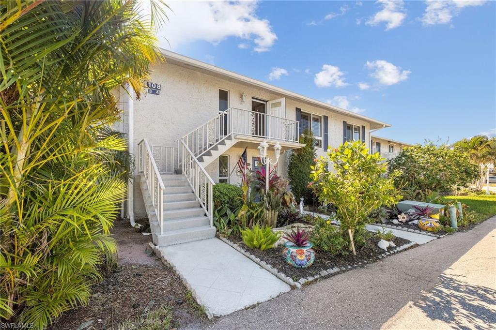 108 Penny Lane, Unit 4 Naples, FL 34112 - Photo 2 of 31 a front view of a house with garden
