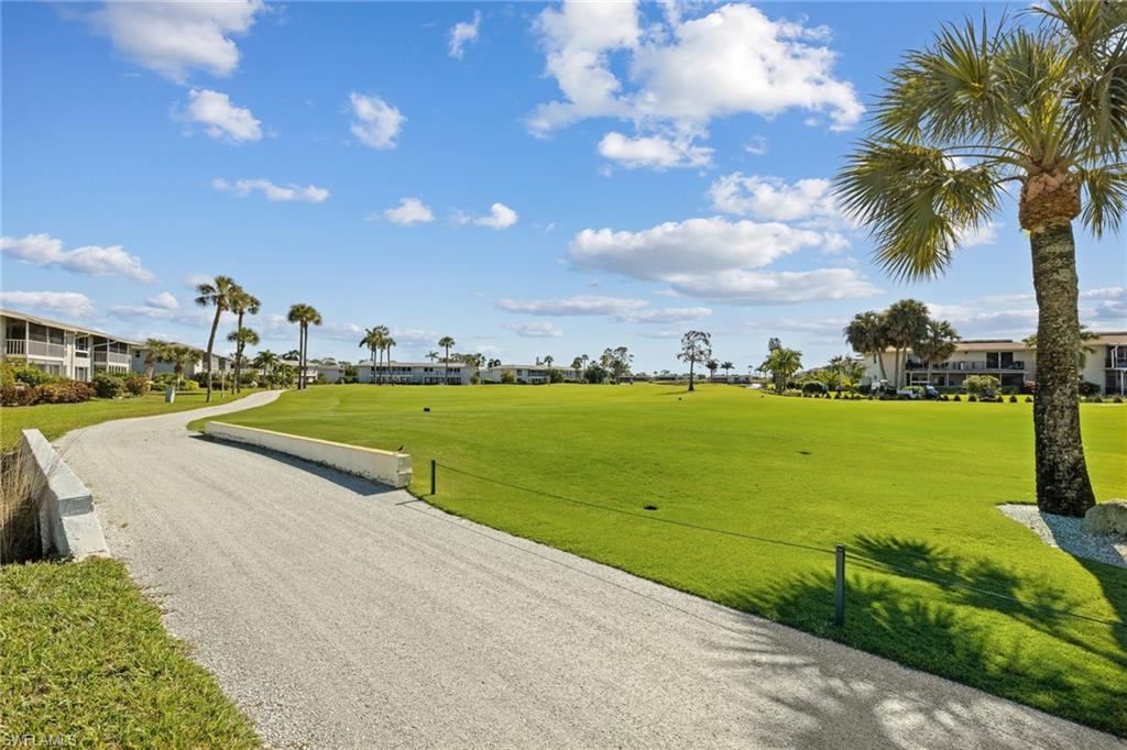 108 Penny Lane, Unit 4 Naples, FL 34112 - Photo 25 of 31 a view of a swimming pool and a yard