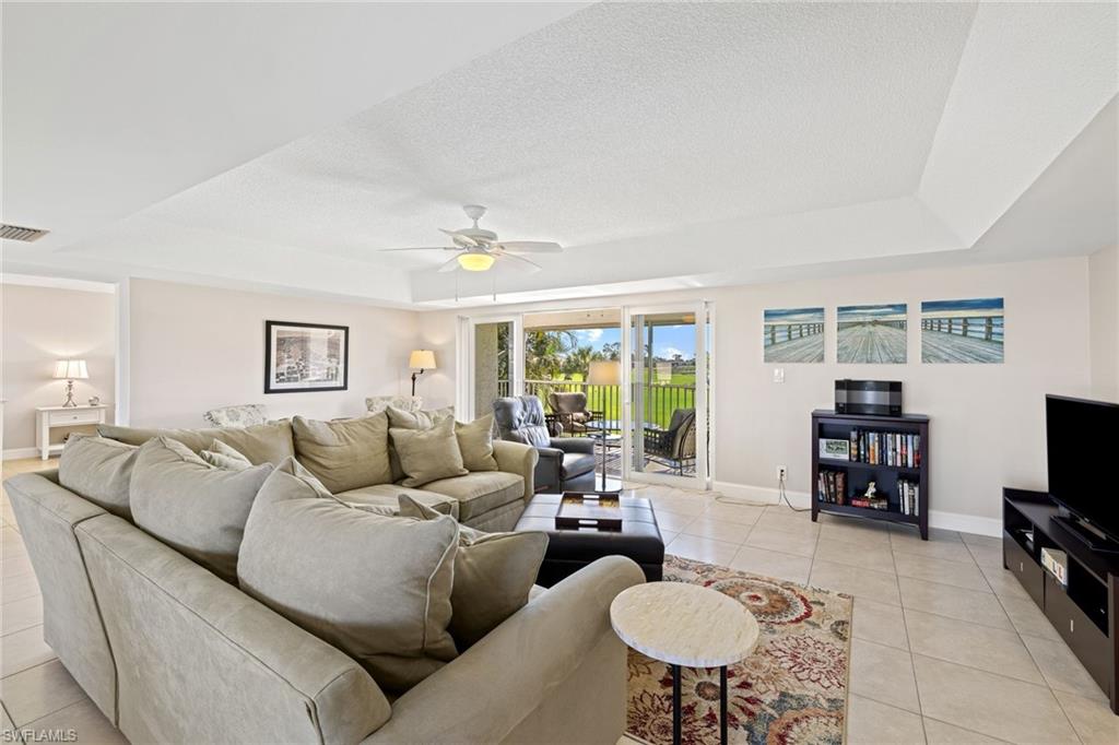 108 Penny Lane, Unit 4 Naples, FL 34112 - Photo 6 of 31 a living room with furniture and a flat screen tv