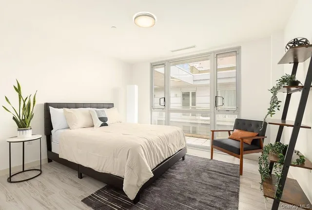 a bedroom with a bed and a large window