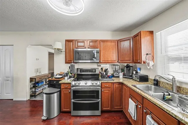 a kitchen with stainless steel appliances a stove sink and cabinets