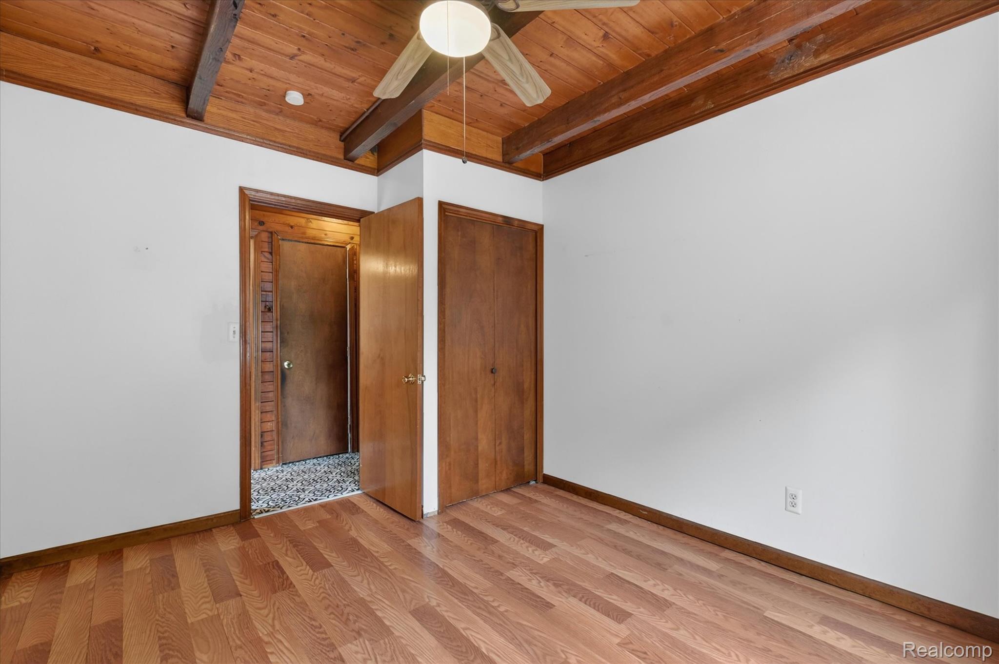 41303 Harris Road Belleville, MI 48111 - Photo 36 of 49 Unfurnished bedroom featuring light wood-style floors, a closet, a wooden ceiling with exposed beams, and a ceiling fan