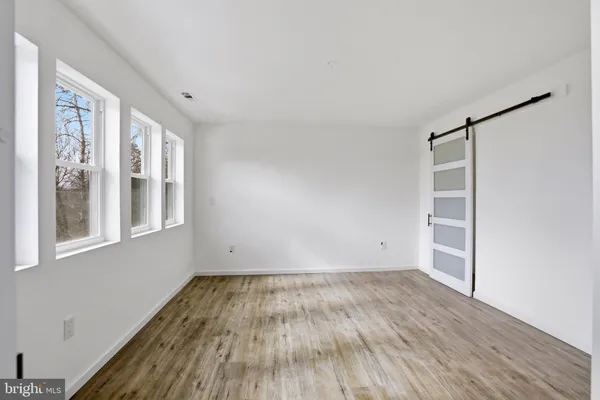 a bedroom with a bed lamp and a window