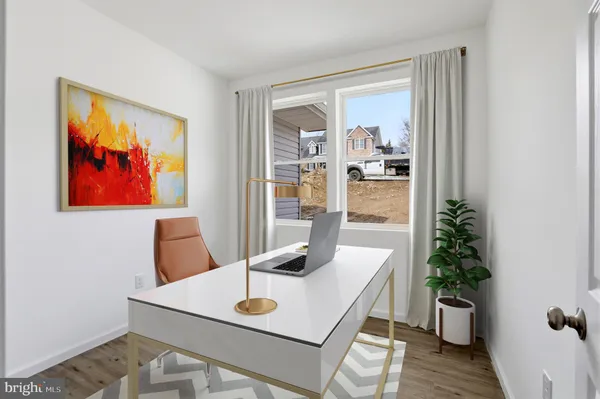 a view of a workspace with furniture and wooden floor