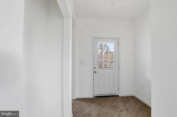 an empty room with wooden floor and closet
