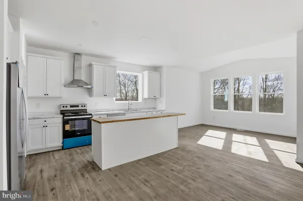 a kitchen with stainless steel appliances granite countertop a stove and a sink
