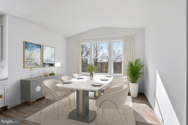 a dining room with furniture and window