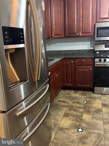 a kitchen with a refrigerator and cabinets