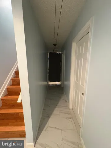 a view of a hallway to rooms