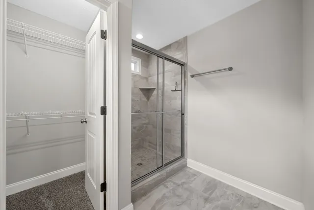 an empty room with windows and closet