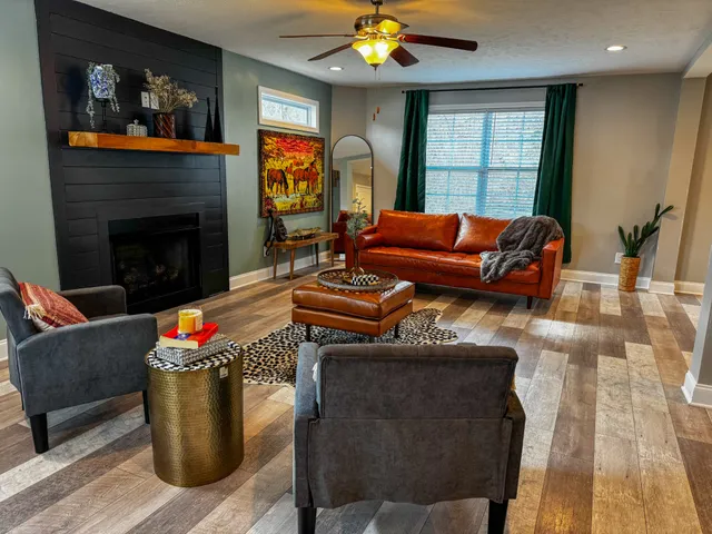 a living room with furniture and a fireplace