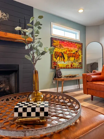 a living room filled with furniture and a fireplace