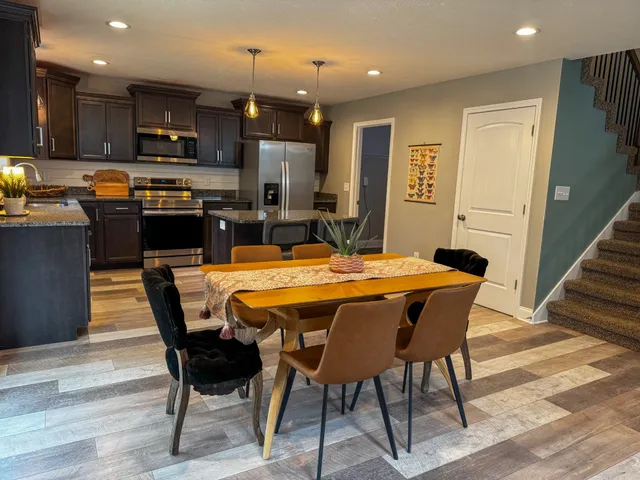 a large kitchen with a table and chairs
