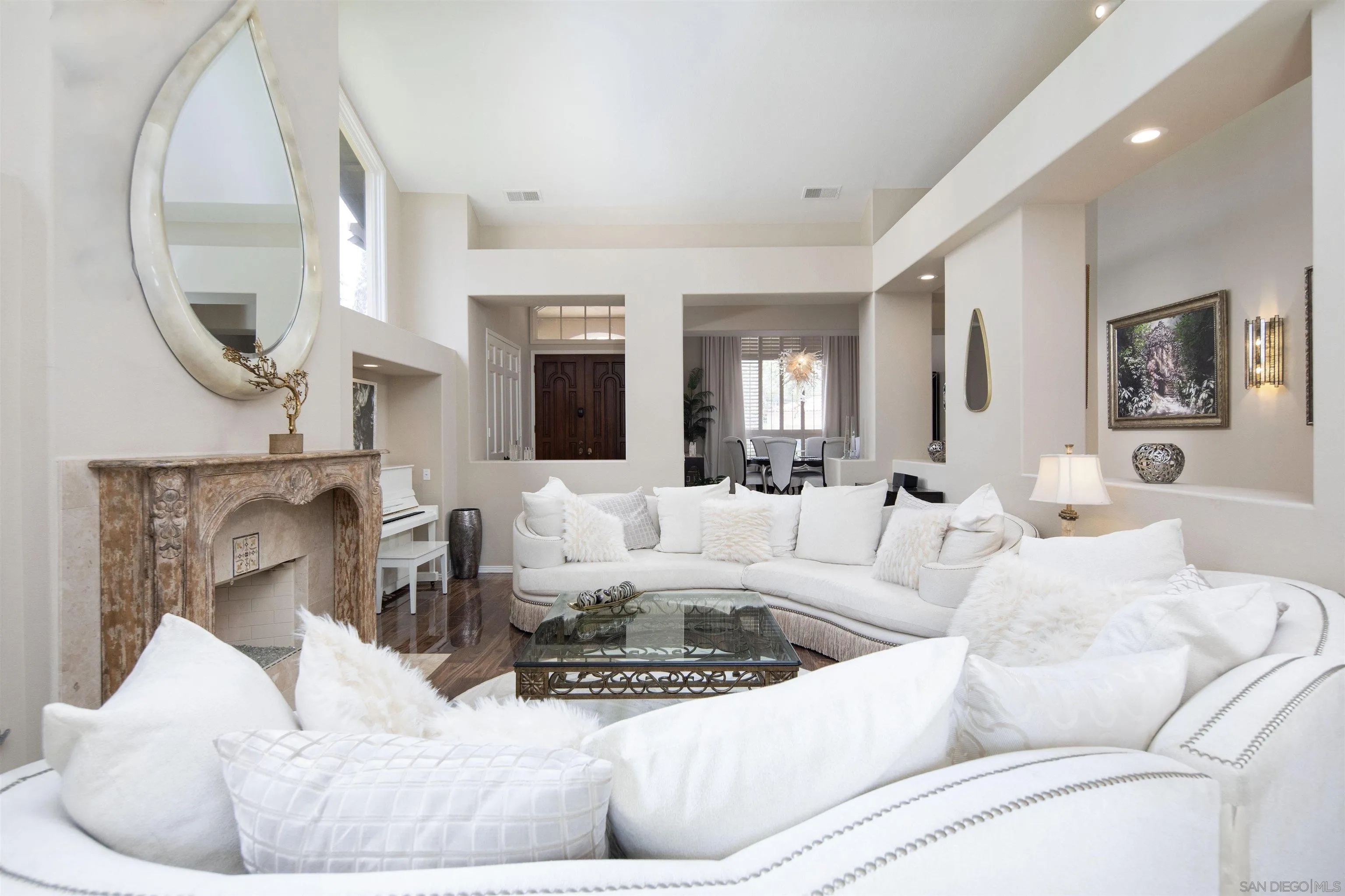 15448 Pimlico Corte Rancho Santa Fe, CA 92067 - Photo 12 of 31 a living room with furniture a mirror and a fireplace
