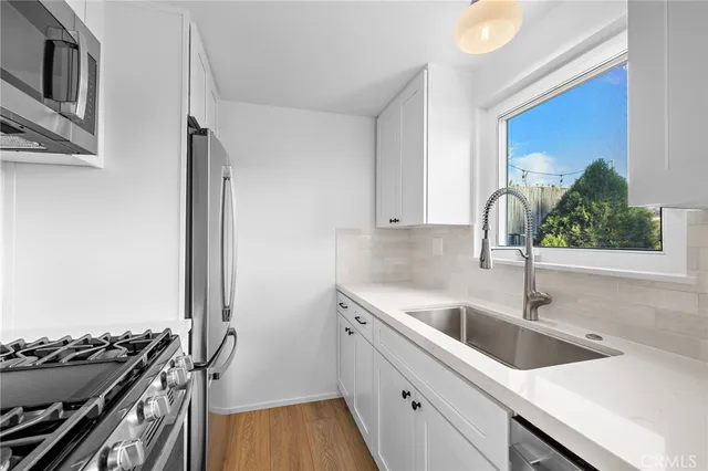 a kitchen with a sink and a stove top oven