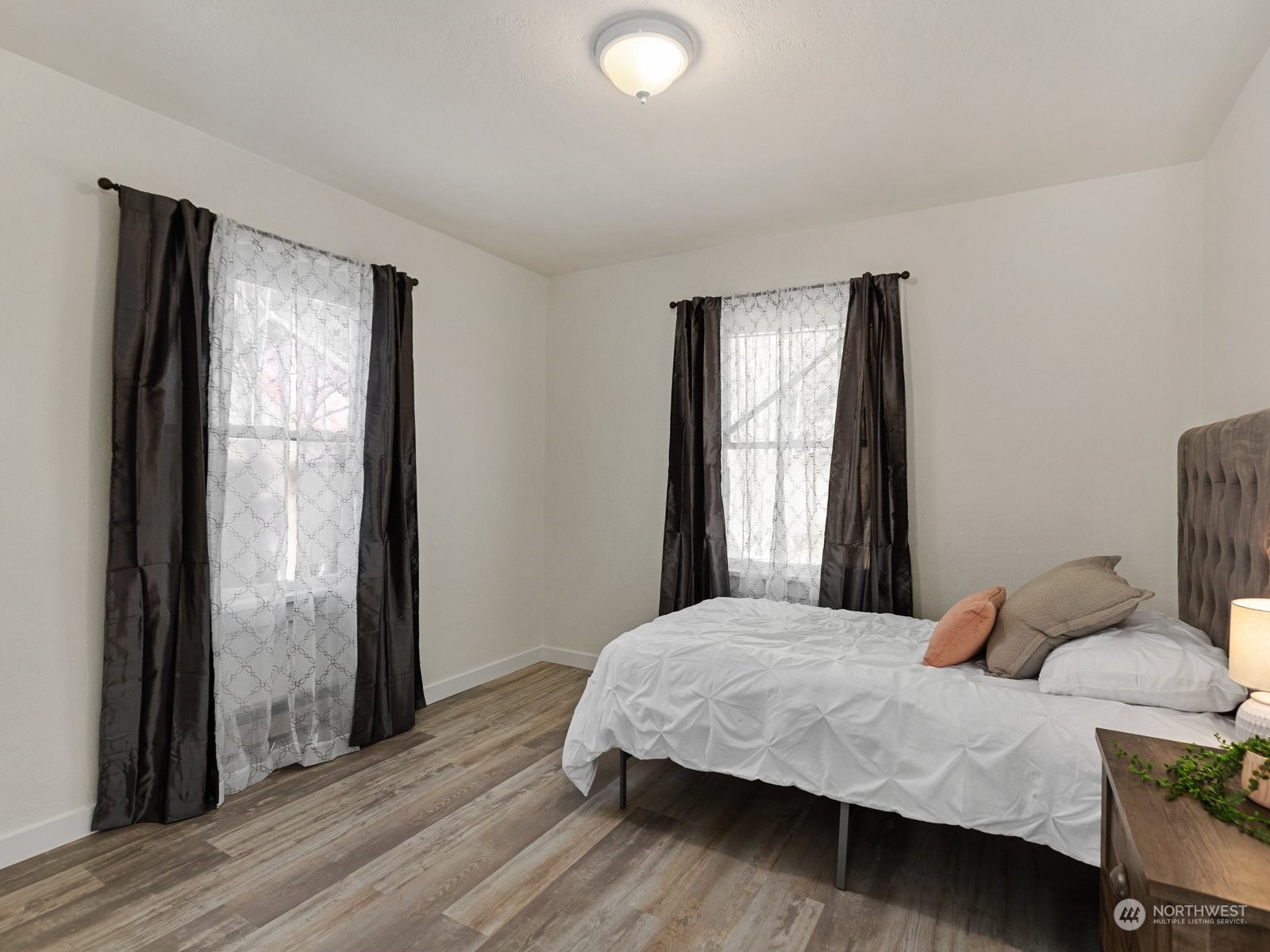 529 Cabot Road Everett, WA 98203 - Photo 16 of 40 a bedroom with a bed and wooden floor