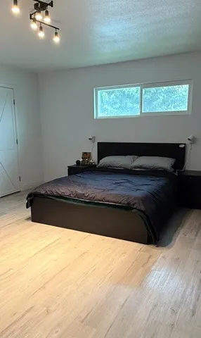 a bathroom with a granite countertop sink and a large window