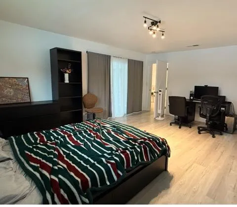 a bedroom with a bed and dresser