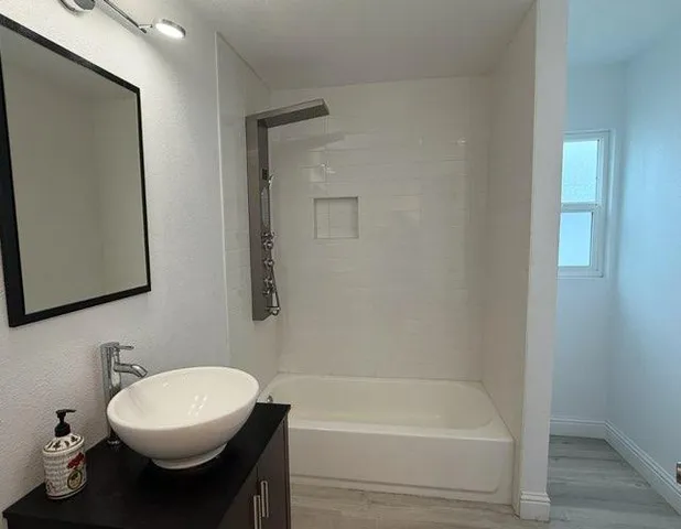 a bathroom with a sink toilet and shower