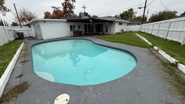 a view of a swimming pool with a patio