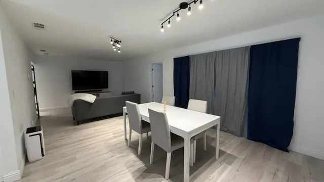a view of a dining room with furniture wooden floor and a chandelier