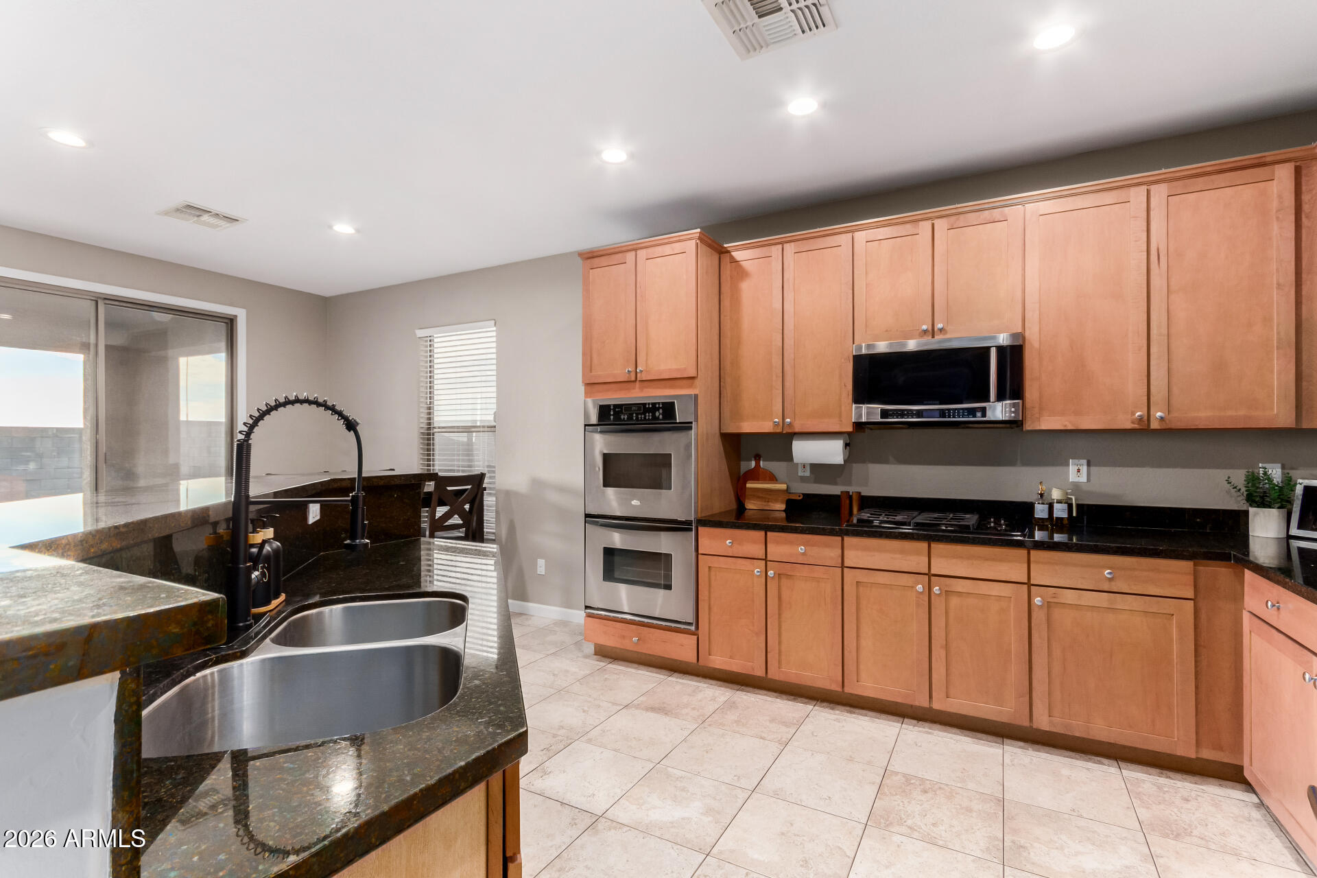 25828 North Desert Mesa Drive Surprise, AZ 85387 - Photo 13 of 37 a kitchen with granite countertop a sink and stainless steel appliances