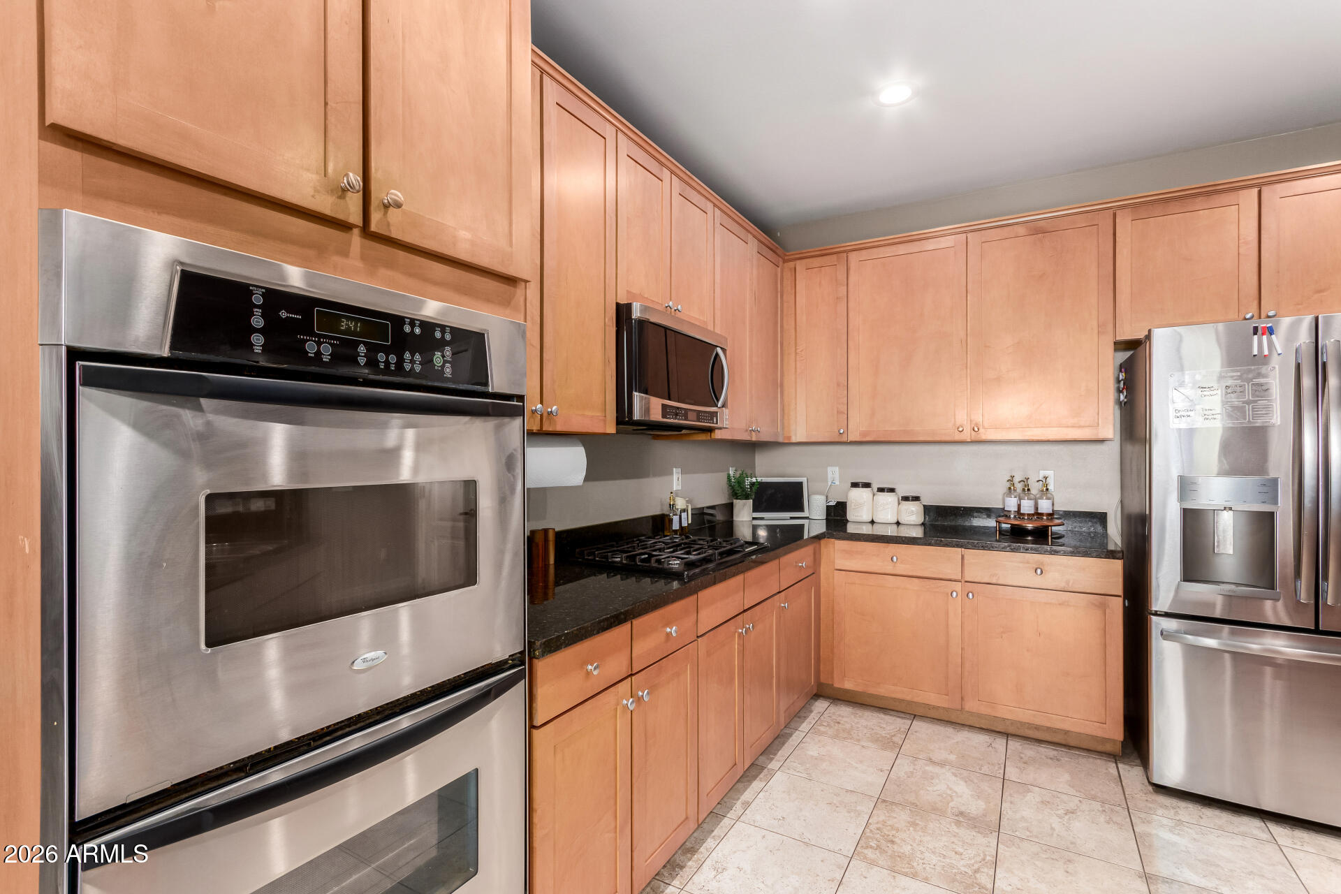 25828 North Desert Mesa Drive Surprise, AZ 85387 - Photo 16 of 37 a kitchen with stainless steel appliances granite countertop a stove a refrigerator and a microwave