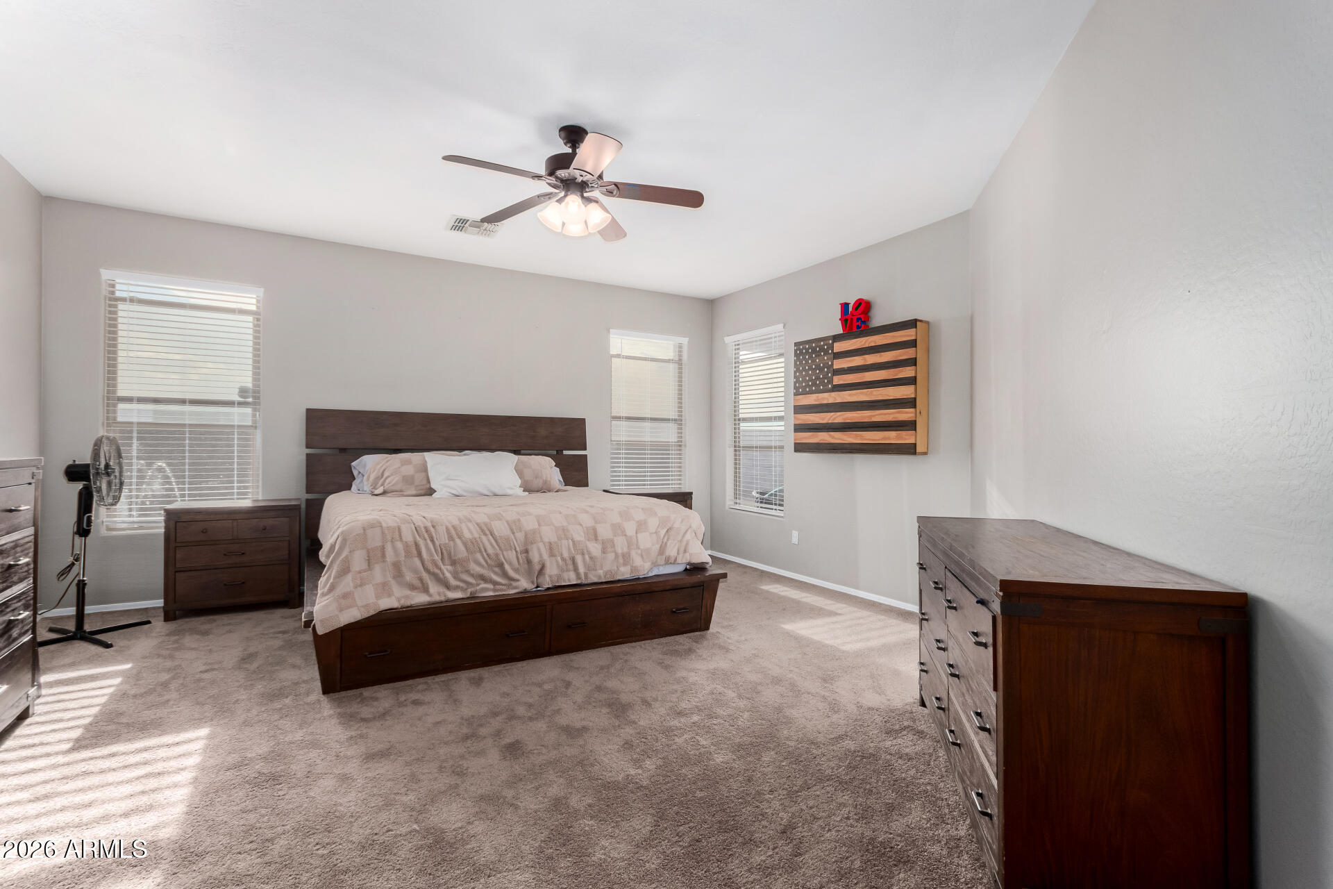 25828 North Desert Mesa Drive Surprise, AZ 85387 - Photo 18 of 37 a bedroom with a bed and a chandelier