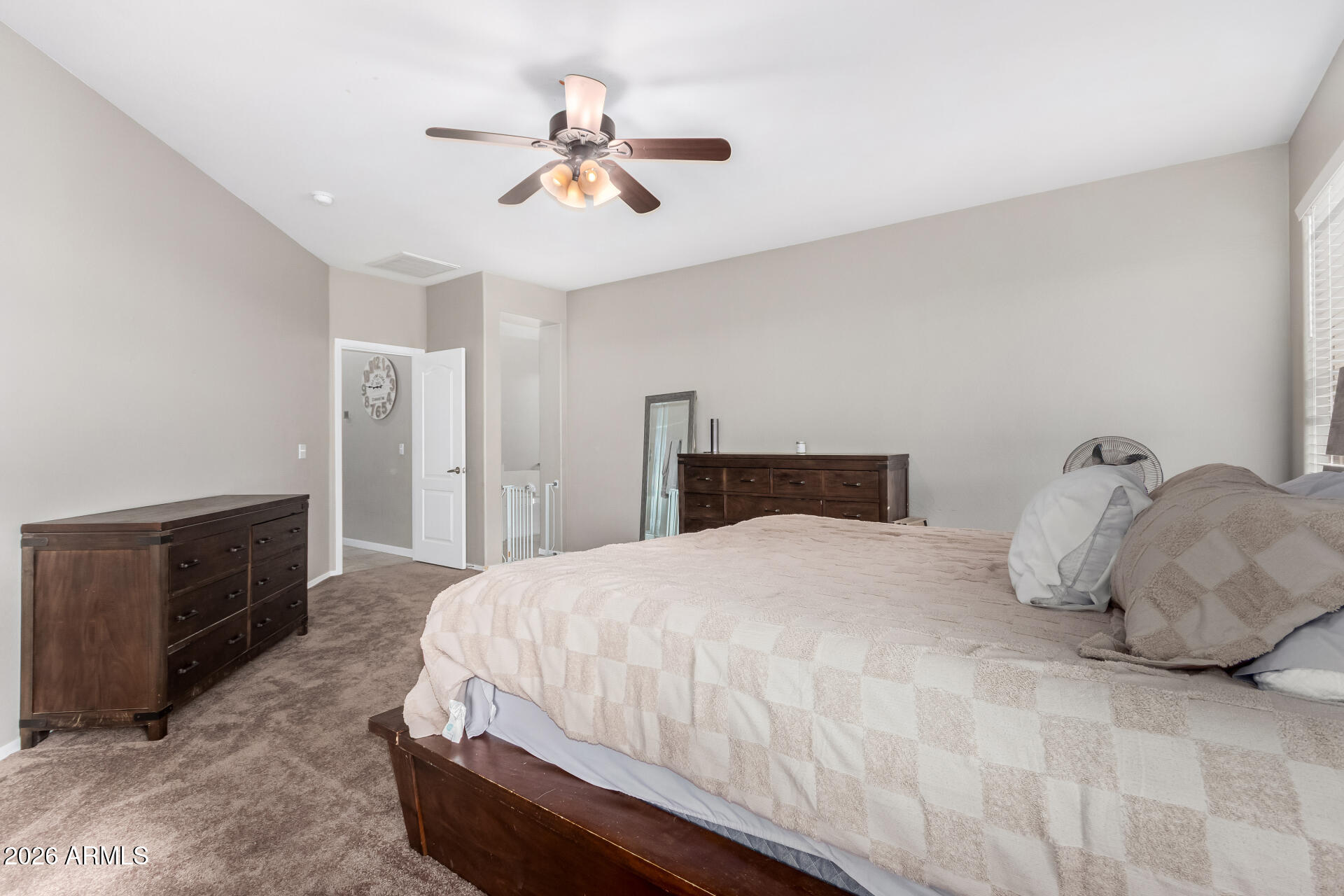 25828 North Desert Mesa Drive Surprise, AZ 85387 - Photo 19 of 37 a bedroom with a bed and dresser