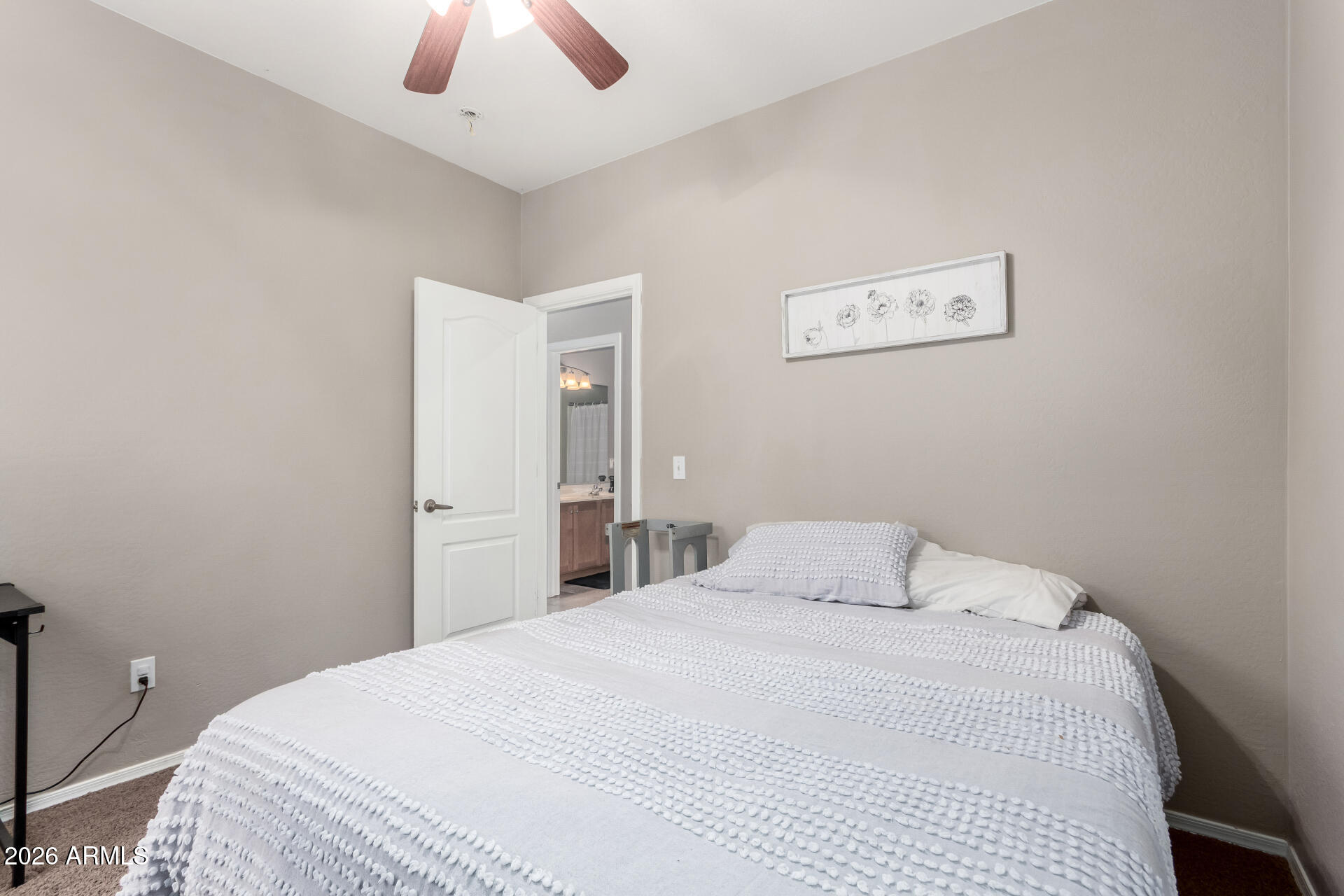 25828 North Desert Mesa Drive Surprise, AZ 85387 - Photo 23 of 37 a bedroom with a bed and a chandelier