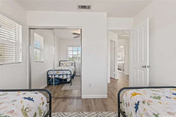 a bedroom with a bed and wooden floor