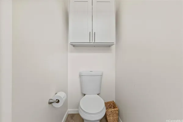 a white toilet sitting in a bathroom