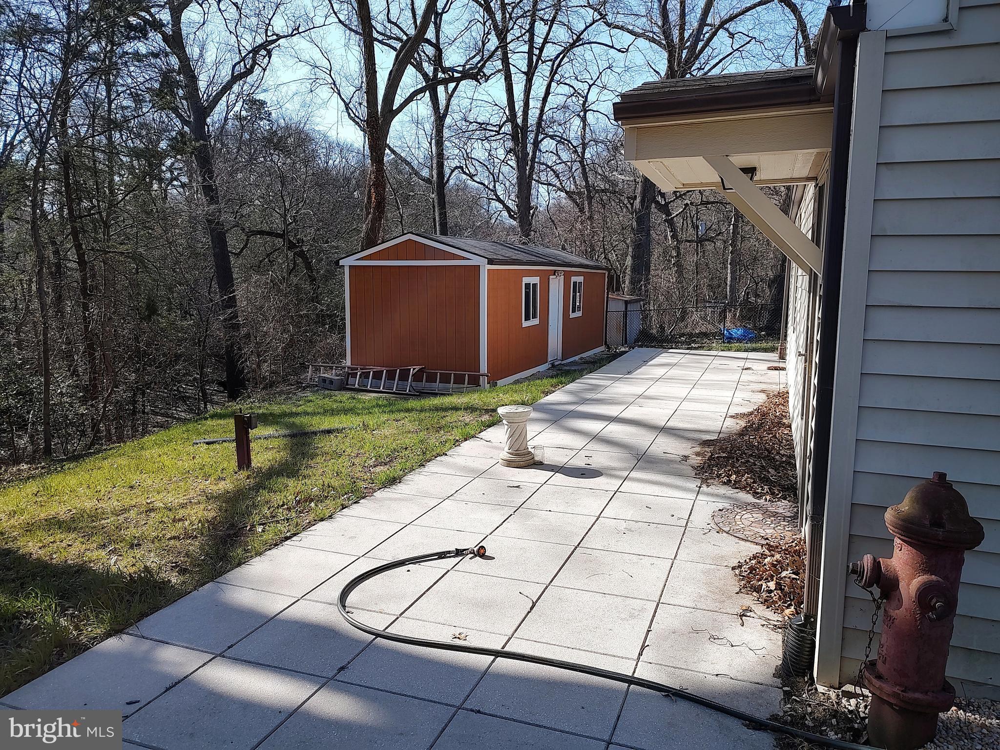 1342 Edna Road Pasadena, MD 21122 - Photo 2 of 3 Rear patio and shed