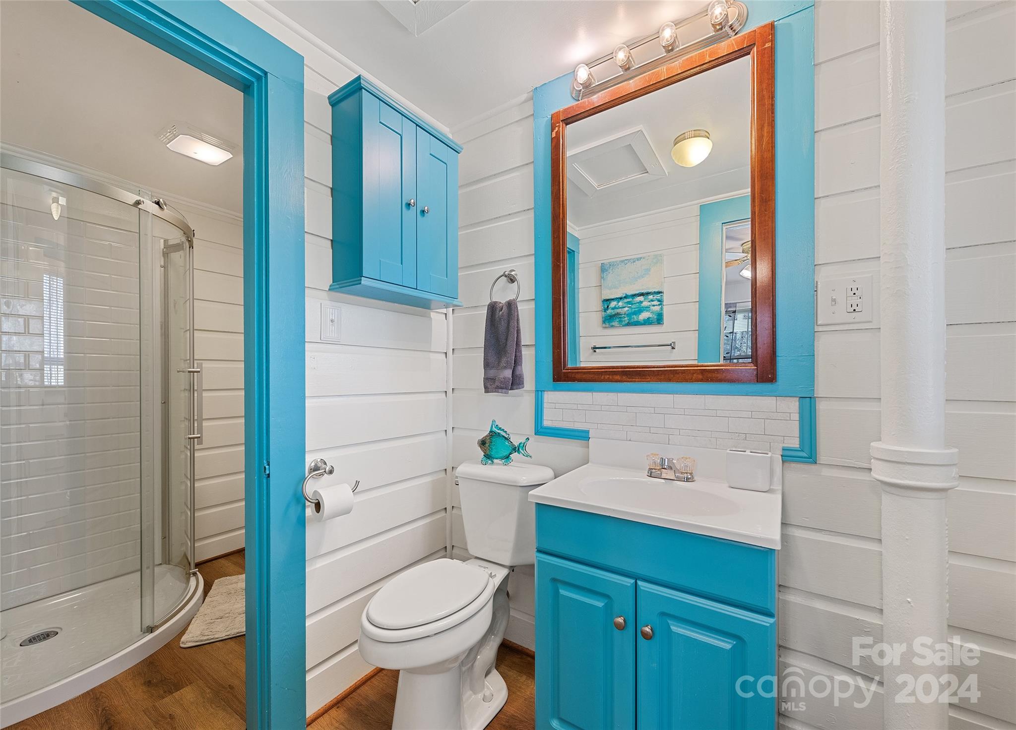 1671 Old Clyde Road Clyde, NC 28721 - Photo 20 of 24 a bathroom with a sink vanity mirror and toilet