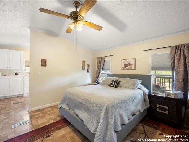 a kitchen with cabinets appliances a sink and a window