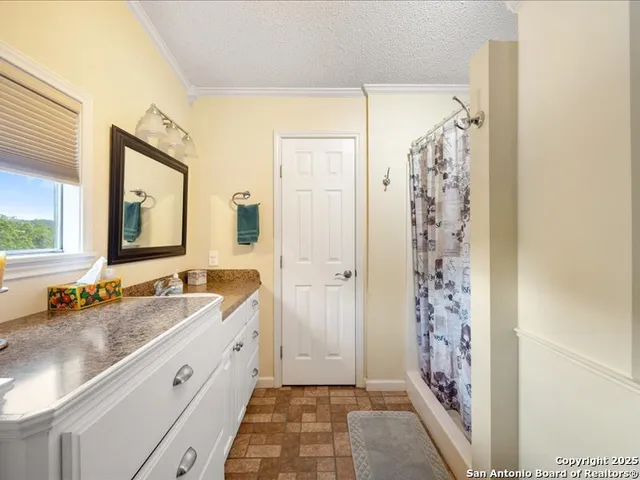 a view of a room that has a bed and a window