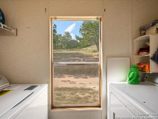 a bathroom with a granite countertop sink toilet a mirror and shower