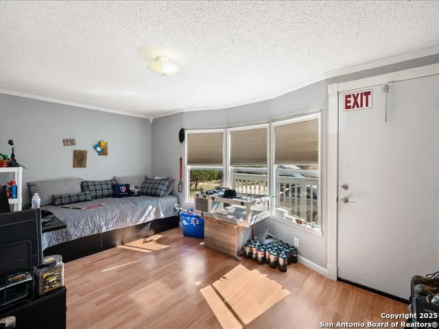 a view of a house with backyard and trees