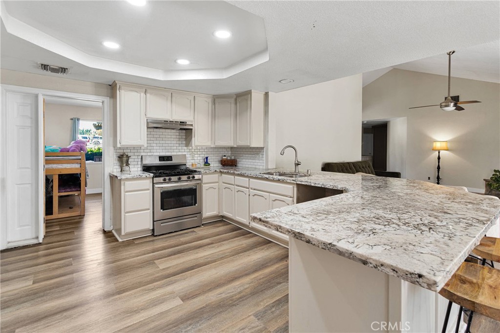 10325 Sheep Creek Road Phelan, CA 92371 - Photo 15 of 47 a kitchen with a sink stove and cabinets