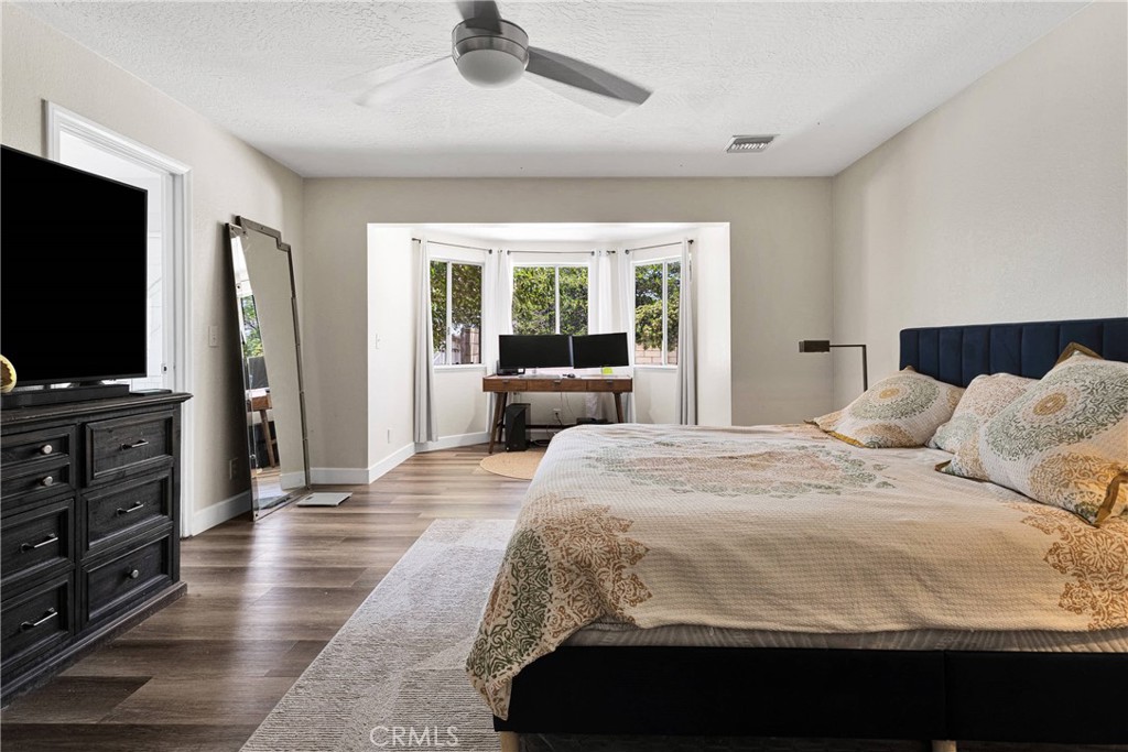 10325 Sheep Creek Road Phelan, CA 92371 - Photo 20 of 47 a bedroom with a bed and a flat screen tv