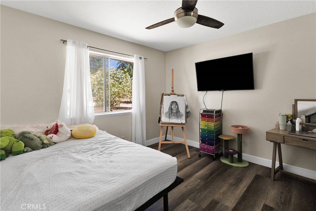 10325 Sheep Creek Road Phelan, CA 92371 - Photo 28 of 47 a bedroom with a bed and a flat screen tv