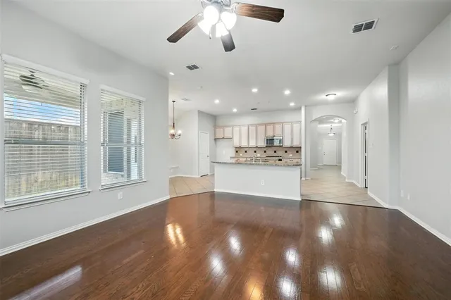 a bathroom with a granite countertop toilet a sink and a mirror