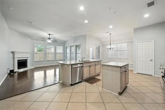 a large kitchen with stainless steel appliances granite countertop a stove and a sink
